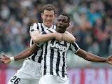 Juventus' Kwadwo Asamoah celebrates with teammate Stephan Lichtsteiner after scoring the opening goal against Chievo Verona during their Serie A match on February 16, 2014
