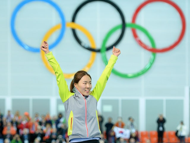 South Korea's Lee Sang-Hwa poses on the podium during the flower ceremony after winning the gold medal in the Women's Speed Skating 500 m at the Adler Arena during the Sochi Winter Olympics on February 11, 2014