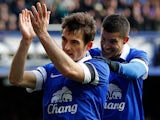 Everton's Leighton Baines celebrates with teammate Kevin Miralla after scoring his team's third goal via the penalty spot against Swansea during their FA Cup fifth round match on February 9, 2014