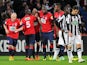 Lille's French forward Nolan Roux is congratulated by his teammates after scoring a goal during the French Cup football match Lille vs Caen on February 11, 2014