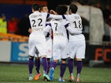 Toulouse's French forward Wissam Ben Yedder celebrates after scoring a goal with his teammates during the French L1 football match between Lorient and Toulouse on February 15, 2014