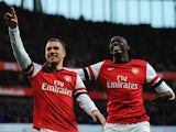 Arsenal's Lukas Podolski celebrates scoring with team mate Yaya Sanogo against Liverpool during their FA Cup fifth round match on February 9, 2014