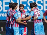 Catania's Mariano Izco celebrates with teammates after scoring his team's opening goal against Lazio in their Serie A match on February 16, 2014