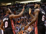 LeBron James #6 of the Miami Heat high fives Toney Douglas #0 after scoring against the Phoenix Suns during the second half of the NBA game at US Airways Center on February 11, 2014