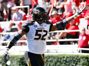 Michael Sam #52 of the Missouri Tigers recovers a fumble for a touchdown against the Georgia Bulldogs at Sanford Stadium on October 12, 2013