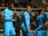 Emmanuel Adebayor of Tottenham Hotspur celebrates scoring the opening goal with team mates during the Barclays Premier League match between Newcastle United and Tottenham Hotspur at St James' Park on February 12, 2014
