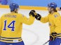 Sweden's Patrik Berglund (L) celebrates with his teammate Sweden's Erik Karlsson after scoring a goal during the Men's Ice Hockey Group C match against Latvia on February 15, 2014