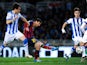 Lionel Messi of FC Barcelona scores the opening goal next to Mikel Gonzalez Martinez of Real Sociedad during the Copa del Rey Semi Final second leg between Real Sociedad and FC Barcelona at Anoeta Stadium on February 12, 2014