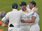 Australian cricketer Mitchell Johnson celebrates with teammates after catching out South Africa's cricketer JP Duminy (unseen) for 25 runs during the second day of the first test match between South Africa and Australia at SuperSport Park in Centurion on 