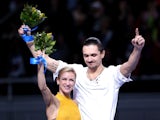 Gold medalists Tatiana Volosozhar and Maxim Trankov of Russia on the podium during the flower ceremony for the Figure Skating Pairs event during day five of the 2014 Sochi Olympics at Iceberg Skating Palace on February 12, 2014