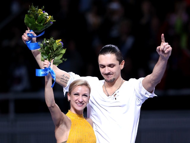 Gold medalists Tatiana Volosozhar and Maxim Trankov of Russia on the podium during the flower ceremony for the Figure Skating Pairs event during day five of the 2014 Sochi Olympics at Iceberg Skating Palace on February 12, 2014