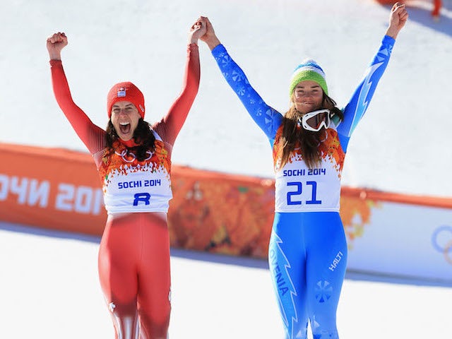 Dominique Gisin of Switzerland and Slovenia's Tina Maze celebrate their shared Winter Olympics gold medal in the women's downhill skiing at Sochi 2014