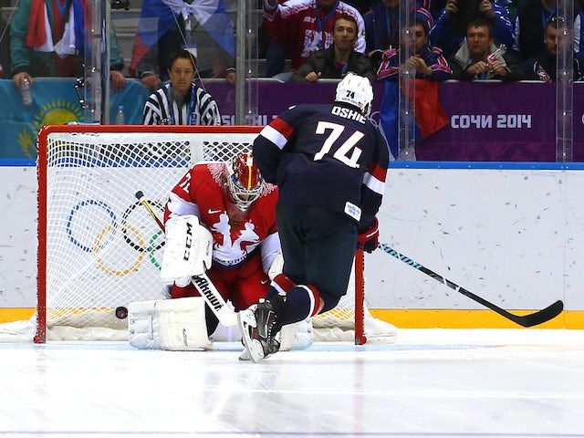 T.J. Oshie of the United States scores on a shootout against Sergei Bobrovski #72 of Russia during the Men's Ice Hockey Preliminary Round Group A game on February 15, 2014