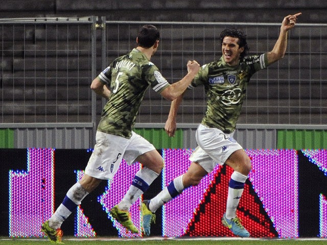 Bastia's French defender Francois Joseph Modesto celebrates with teammates after scoring a goal during the French L1 football match Toulouse against Bastia on February 11, 2014