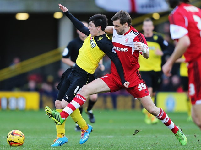 Fernando Forestieri of Watford holds off the challenge of Jonathan Woodgate of Middlesbrough during the Sky Bet Championship match between Watford and Middlesbrough at Vicarage Road on February 15, 2014
