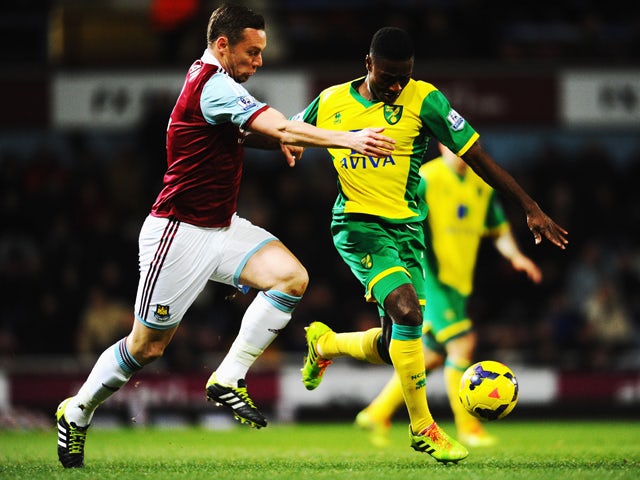 Kevin Nolan of West Ham United challenges Alexander Tettey of Norwich City during the Barclays Premier League match between West Ham United and Norwich City at the Boleyn Ground on February 11, 2014
