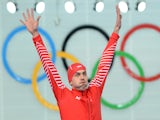 Poland's gold medalist Zbigniew Brodka poses on the podium during the Men's Speed Skating 1500 m Flower Ceremony at the Adler Arena during the Sochi Winter Olympics on February 15, 2014