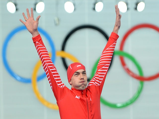 Poland's gold medalist Zbigniew Brodka poses on the podium during the Men's Speed Skating 1500 m Flower Ceremony at the Adler Arena during the Sochi Winter Olympics on February 15, 2014