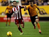Zeli Ismail of Wolves battles with Sam Saunders of Brentford during the Sky Bet League One game between Wolverhampton Wanderers and Brentford at Molineux on November 23, 2013