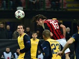 AC Milan's midfielder Andrea Poli heads the ball during their Champions League match between AC Milan and Atletico Madrid , on February 19, 2014