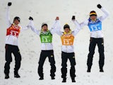 Gold medalists Andreas Wank, Marinus Kraus, Andreas Wellinger and Severin Freund of Germany celebrate during the flower ceremony for the Men's Team Ski Jumping final on February 17, 2014