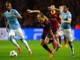 Andres Iniesta of Barcelona competes with Jesus Navas of Manchester City during the UEFA Champions League Round of 16 first leg match on February 18, 2014