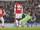 Bayern Munich's goalkeeper Manuel Neuer saves a penalty kick from Arsenal's German midfielder Mesut Ozil during the UEFA Champions League Last 16, first leg football match between Arsenal and Bayern Munich at The Emirates Stadium in north London on Februa