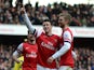 Laurent Koscielny of Arsenal celebrates with team-mates Olivier Giroud of Arsenal and Per Mertesacker of Arsenal after scoring their third goal during the Barclays Premier League match between Arsenal and Sunderland at Emirates Stadium on February 22, 201