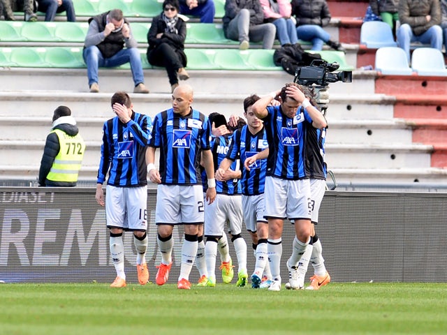 Davide Brivio of Atalanta BC is mobbed by team mates after scoring his opening goal during the Serie A match between Udinese Calcio and Atalanta BC at Stadio Friuli on February 23, 2014