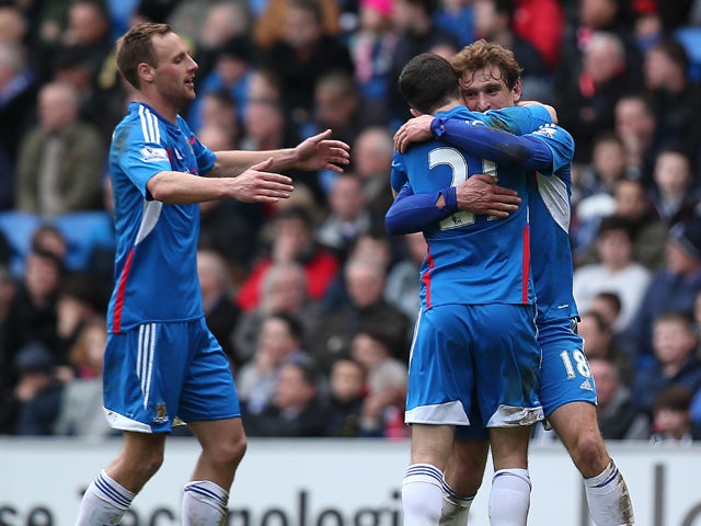 Nikica Jelavic of Hull celebrates with team mates after scoring the team's second goal during the Barclays Premier League match between Cardiff City and Hull City at Cardiff City Stadium on Febuary 22, 2014