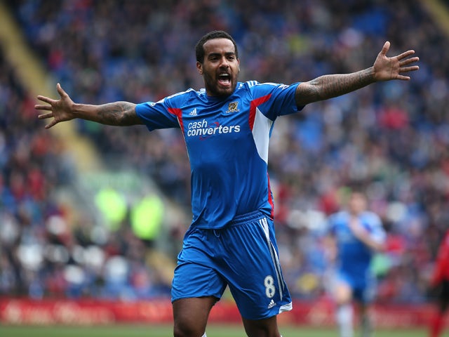Tom Huddlestone of Hull celebrates after scoring the first goal of the game during the Barclays Premier League match between Cardiff City and Hull City at Cardiff City Stadium on Febuary 22, 2014
