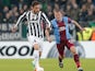 Juventus' Claudio Marchisio and Trabzonspor's Alexandru Bourceanu in action during their Europa League match on February 20, 2014
