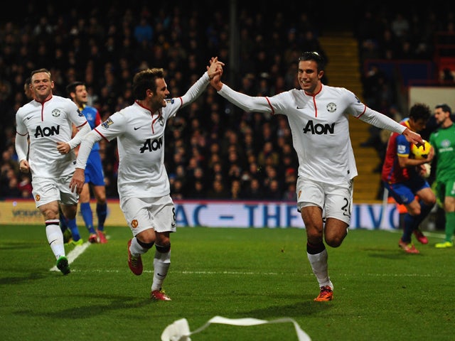Robin Van Persie of Man United celebrates with Juan Mata after scoring from the spot during the Barclays Premier League match between Crystal Palace and Manchester United at Selhurst Park on February 22, 2014 