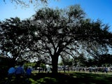 Patrons walking past the Eisenhower Tree during the third round of the 2012 Masters Tournament at Augusta National Golf Club on April 7, 2012