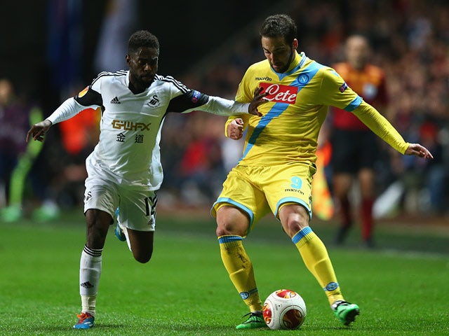 Swansea's Nathan Dyer and Napoli's Gonzalo Higuain in action during their Europa League match on February 20, 2014