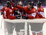 Canada's players celebrating after winning the Men's Ice Hockey Semifinal match between the USA and Canada at the Bolshoy Ice Dome during the Sochi Winter Olympics on February 21, 2014