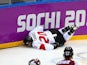  John Tavares #20 of Canada crashes into the boards during the Men's Ice Hockey Quarterfinal Playoff against Latvia during the 2014 Sochi Winter Olympics on February 19, 2014