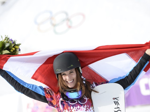 Gold Medallist, Austria's Julia Dujmovits celebrates at the Women's Snowboard Parallel Slalom Flower Ceremony at the Rosa Khutor Extreme Park during the Sochi Winter Olympics on February 22, 2014