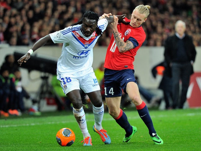 Lille's Danish defender Simon Kjaer vies for the ball with Lyon's French forward Bafetimbi Gomis during the French L1 football match Lille (LOSC) vs Lyon (OL) on February 23, 2014