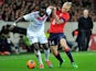 Lille's Danish defender Simon Kjaer vies for the ball with Lyon's French forward Bafetimbi Gomis during the French L1 football match Lille (LOSC) vs Lyon (OL) on February 23, 2014