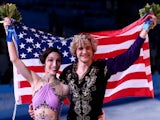 Gold medalists Meryl Davis and Charlie White of the United States celebrate during the flower ceremony for the Figure Skating Ice Dance on February 17, 2014