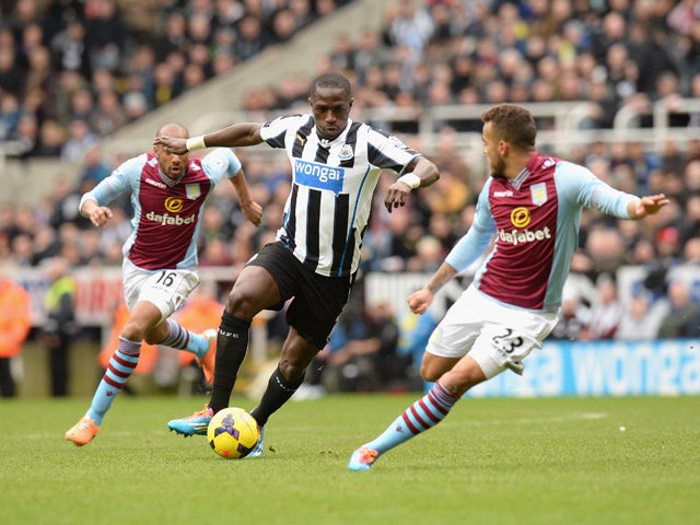 Moussa Sissoko of Newcastle United looks to get past Ryan Bertrand of Aston Villa during the Barclays Premier League match between Newcastle United and Aston Villa at St James' Park on February 23, 2014