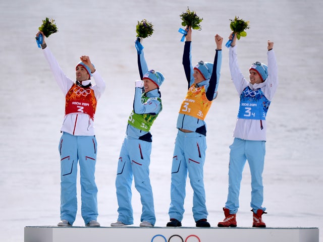 Norway's Magnus Hovdal Moan, Haavard Klemetsen, Magnus Krog and Joergen Graabak celebrate their gold medal on the podium at the Nordic Combined Team LH / 4x5 km Flower Ceremony at the RusSki Gorki Jumping Center during the Sochi Winter Olympics on Februar