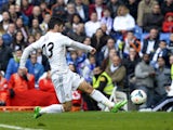 Real Madrid's midfielder Isco kicks to score during the Spanish league football match Real Madrid vs Elche at the Santiago Bernabeu stadium in Madrid on February 22, 2014