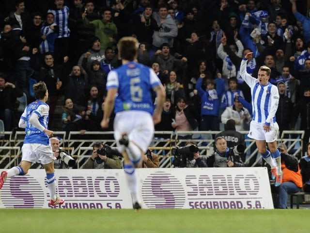 Real Sociedad's French forward Antoine Griezmann celebrates after scoring during the Spanish league football match Real Sociedad vs FC Barcelona at the Anoeta stadium in San Sebastian on February 22, 2014