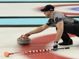 Canada's Ryan Harnden throws the stone during the Men's Curling Round Robin Session 7 at the Ice Cube Curling Center during the Sochi Winter Olympics on February 14, 2014
