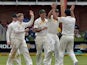 Australia team celebrates the wicket of South Africa's batsman Quinton de Kock during the second test match between South Africa and Australia at St George's Park, in Port Elizabeth on February 20, 2014