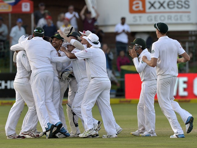 South Africa's cricketers celebrate their win over Australia in the second test match between South Africa and Australia at St George's Park in Port Elizabeth on February 23, 2014