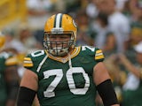 T.J. Lang #70 of the Green Bay Packers participates in warm-ups before a preseason game against the Cleveland Browns at Lambeau Field on August 16, 2012