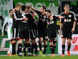 Leverkusen´s players celebrate during the German first division Bundesliga football match VfL Wolfsburg vs Bayer Leverkusen on February 22, 2014 